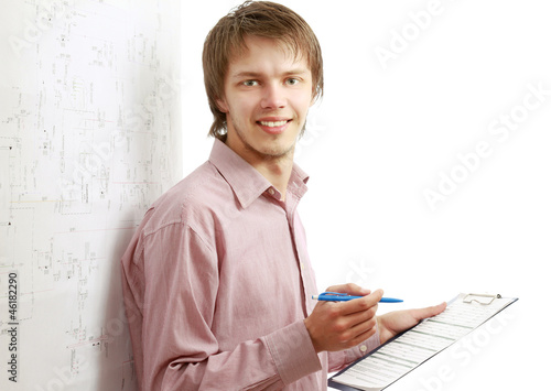 A smiling businessman is filling papers photo