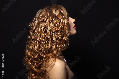 Portrait of a beautiful girl with curly hair