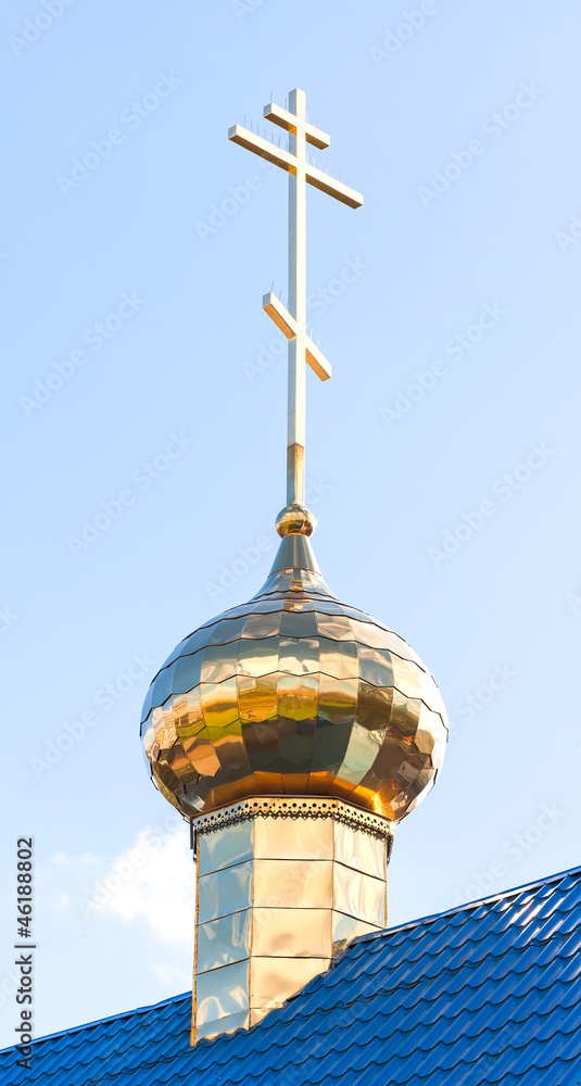 Golden dome with cross of small Orthodox church