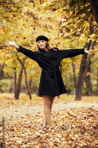Redhead girl in the autumn park.