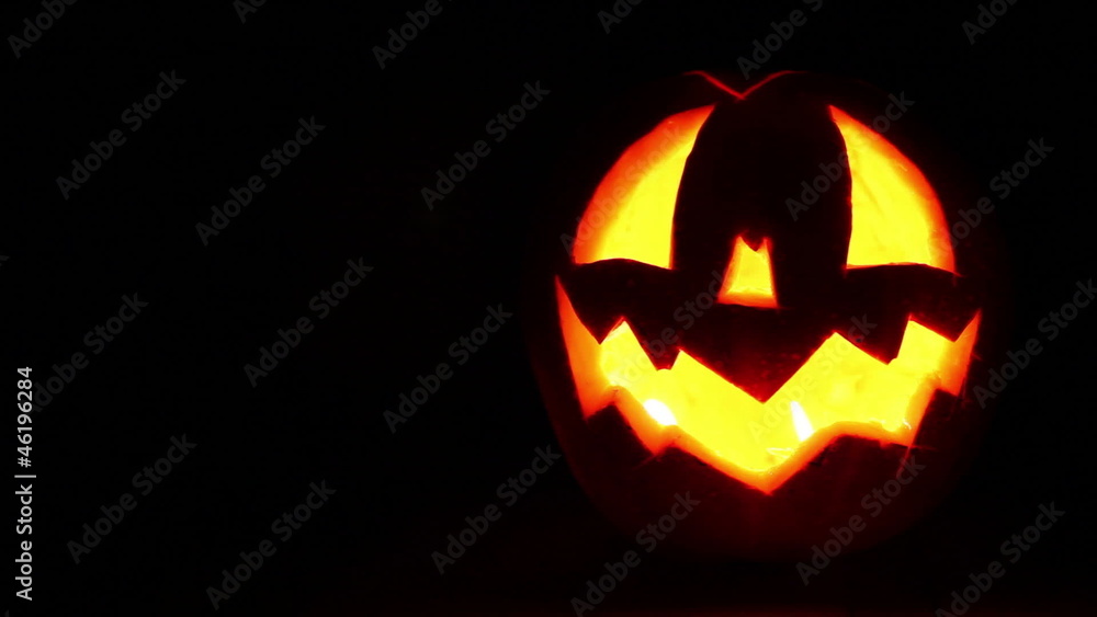 Jack-o'-lantern with Candles inside full Dark background Footage Jack-o'-lantern with Candles inside full Dark background Footage
