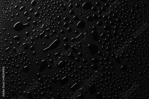 Water drops on black surface photo