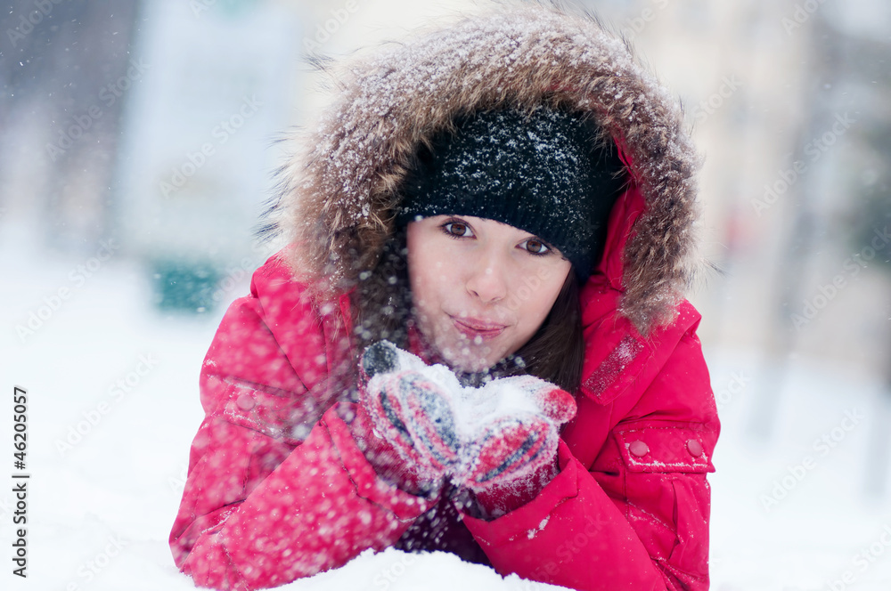 Happy young woman plays with a snow Happy young woman plays with a snow