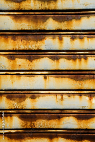 Old rusty metal slat door