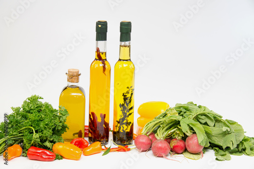 Fototapeta Naklejka Na Ścianę i Meble -  Olive oil in bottle with peppers and vegetable