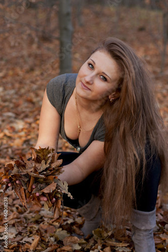 beautiful girl in the autumn forest of yellow leaves