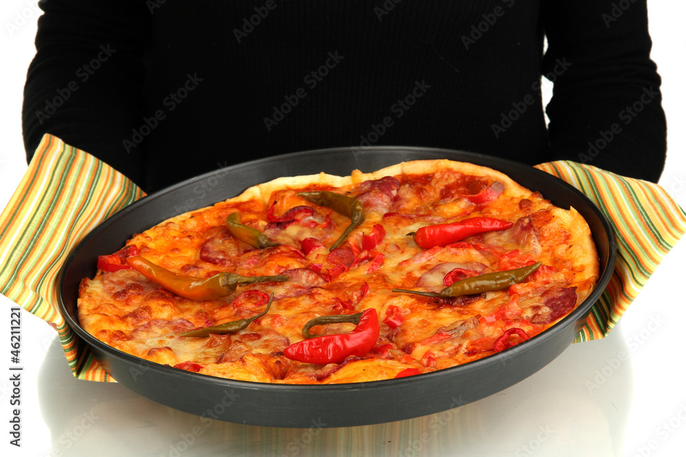 hands holding pepperoni pizza in pan close-up