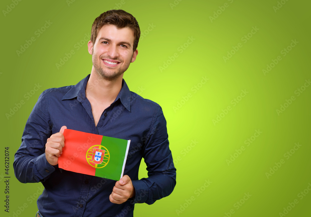 Man Holding A Miniature Airplane And Portugal Flag Man Holding A Miniature Airplane And Portugal Flag