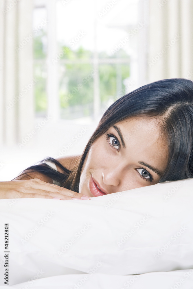 Portrait of young beautiful woman on white sheet Portrait of young beautiful woman on white sheet