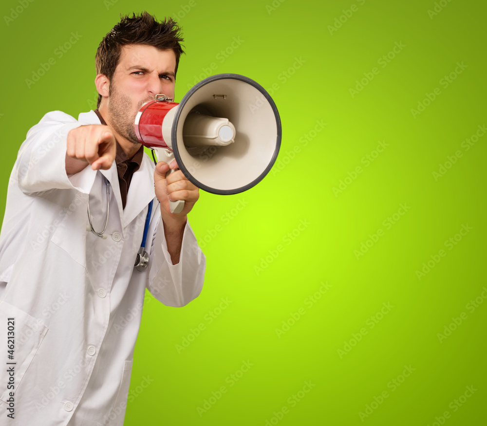 Portrait Of A Male Doctor Shouting On Megaphone Portrait Of A Male Doctor Shouting On Megaphone