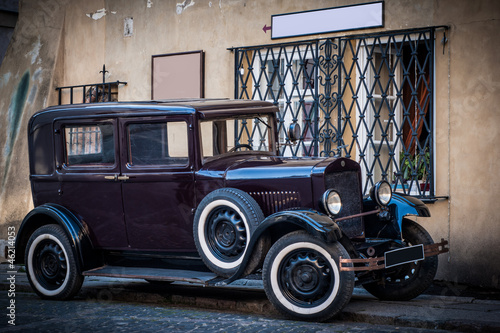 old vintage car in city background with empty spaces on wall