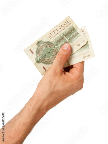 Very old Surinam money in the hands of an old woman