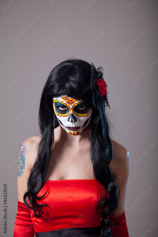 Young woman with sugar skull Halloween make-up Young woman with sugar skull Halloween make-up
