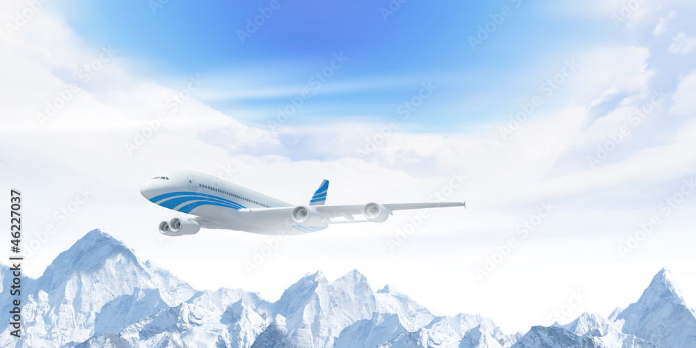 White passenger plane above the mountains