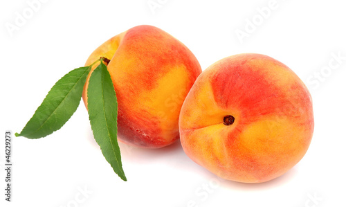 Two sweet peaches with leaves