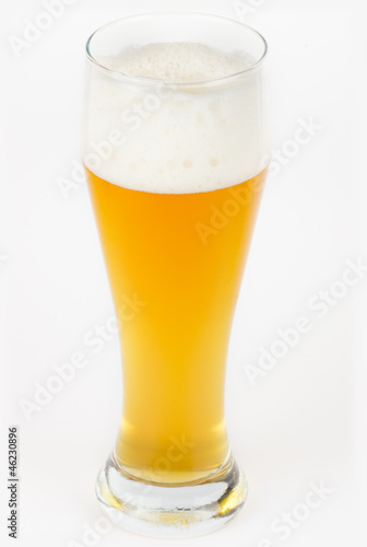 A glass with unfiltered beer on white