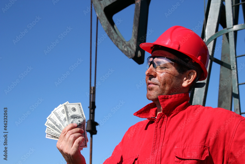 Oil Worker With Dirty Face Holding US Dollar Bills Oil Worker With Dirty Face Holding US Dollar Bills
