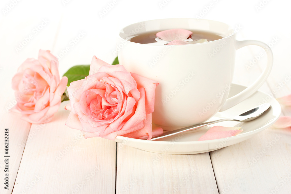 cup of tea with roses on white wooden table cup of tea with roses on white wooden table
