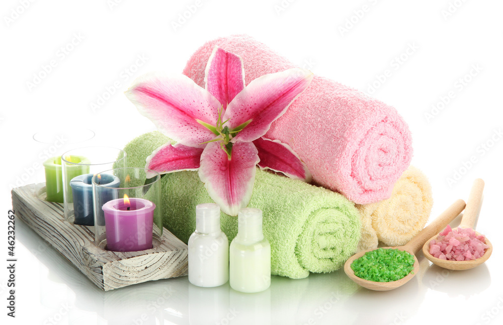 towels with lily, aroma oil, candles and sea salt isolated towels with lily, aroma oil, candles and sea salt isolated