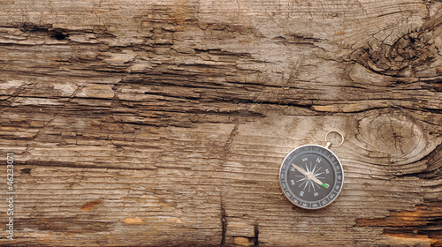 Compass on the old wooden background