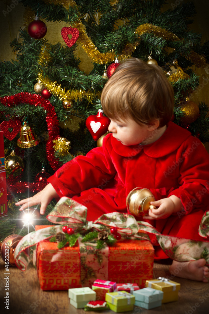 baby play with present box at Christmas tree baby play with present box at Christmas tree