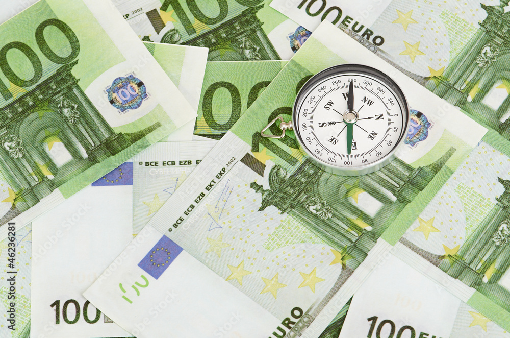 euro bank notes and a compass euro bank notes and a compass