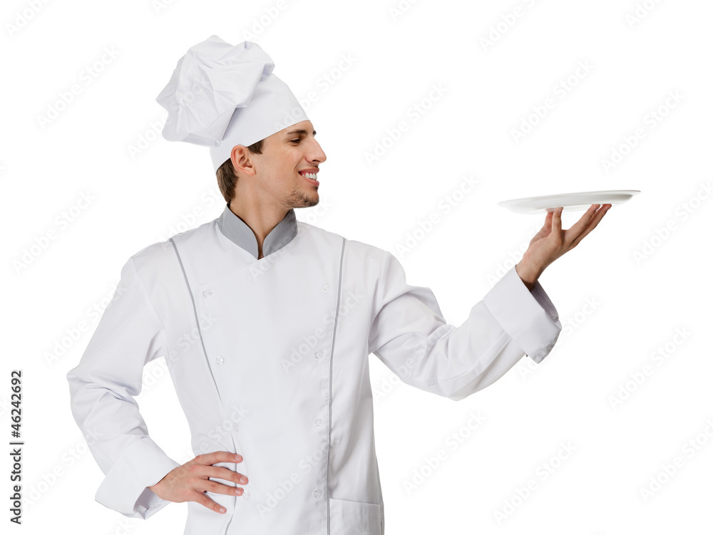 Chief cook in uniform handing a white plate, isolated on white Chief cook in uniform handing a white plate, isolated on white