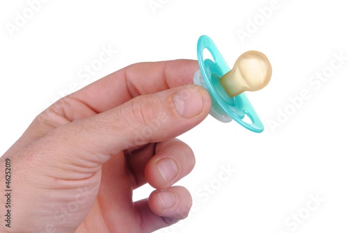 man hand with a baby dummy, isolated on white