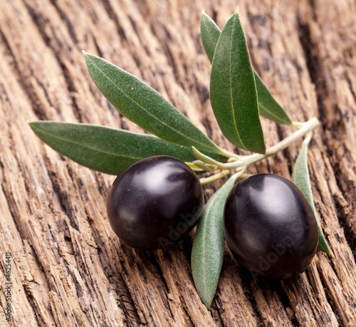 Ripe black olives with leaves.