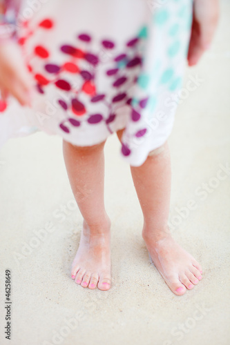 Child legs on beach
