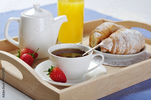 Breakfast with tea and croissants