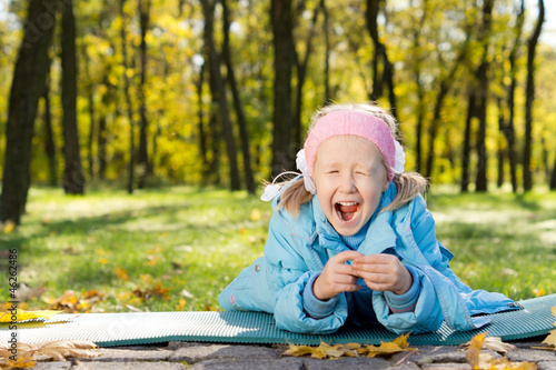 Fototapeta Naklejka Na Ścianę i Meble -  Young Girl in a Park Yawning