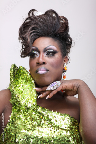 Drag queen wearing a green gown with sequins.
