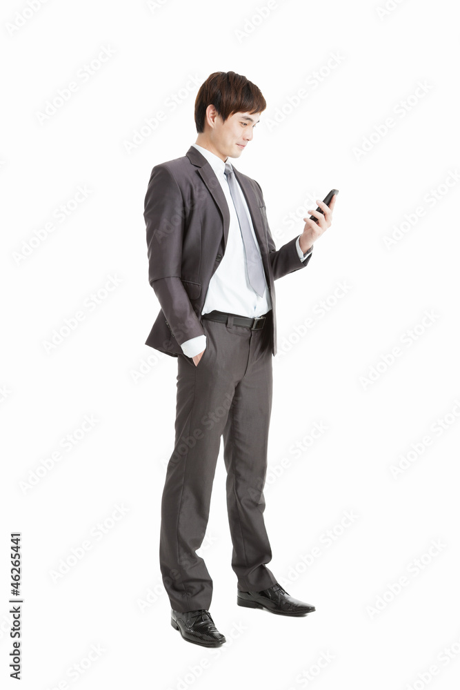 full length of Successful businessman holding smart phone isolat full length of Successful businessman holding smart phone isolat