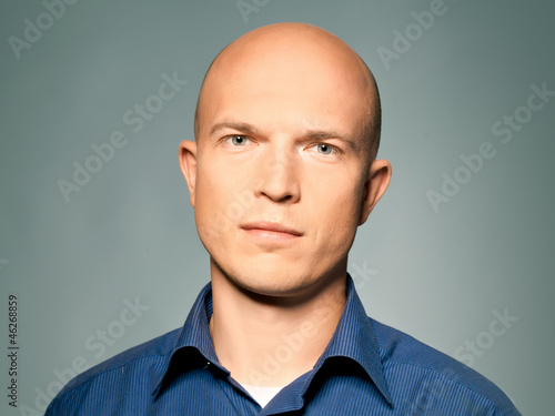 Handsome friendly  bold man wearing blue skirt