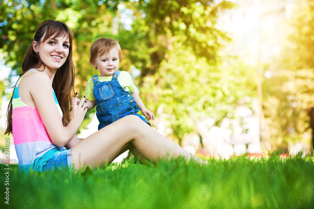 funny baby with mom in a greenl summer park funny baby with mom in a greenl summer park