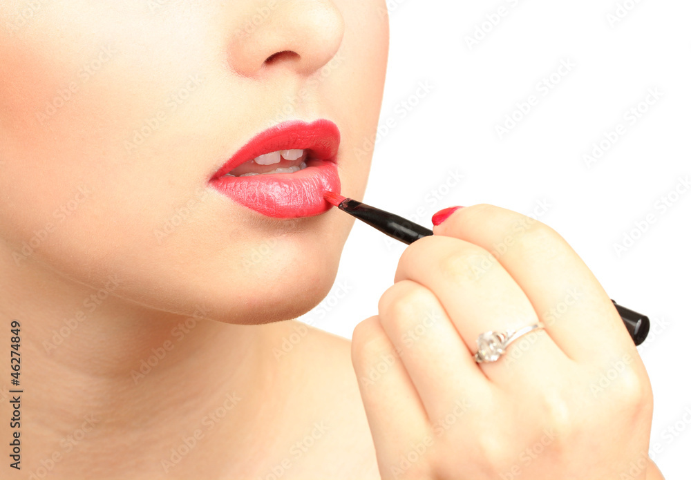beautiful woman applying lip gloss