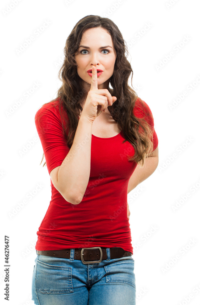 Beautiful woman dressed in red doing a silence sign Beautiful woman dressed in red doing a silence sign