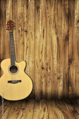 acoustic guitar on wood background