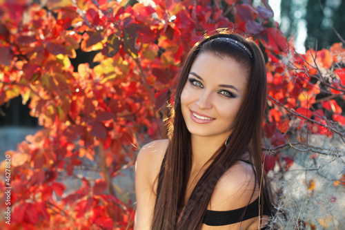 Happy smiling teen brunette girl. Autumn Woman Outdoors Portrait