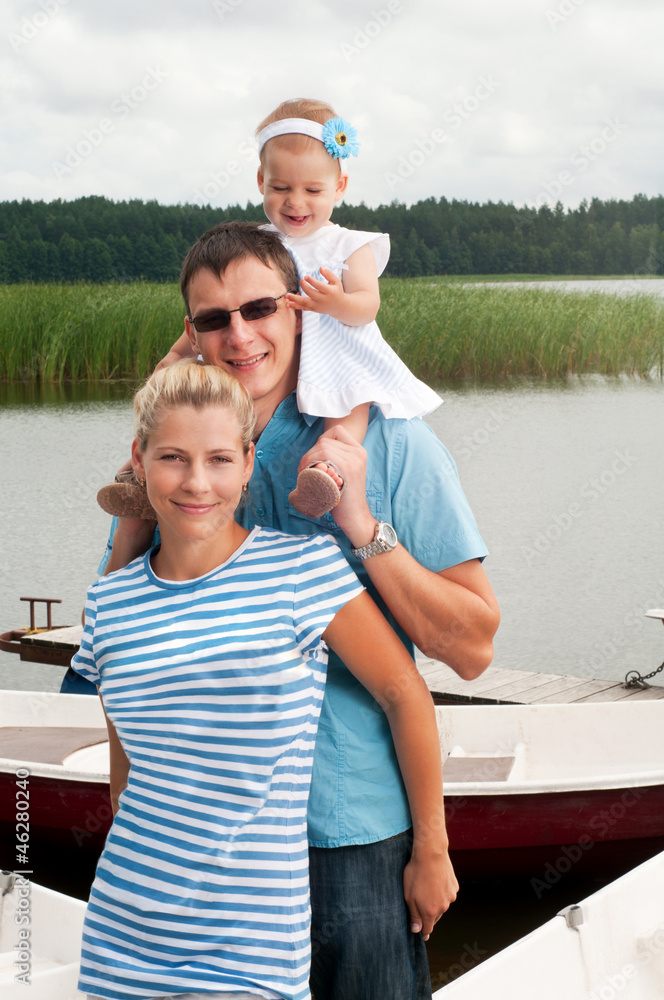Fototapeta premium Happy family on the river bank