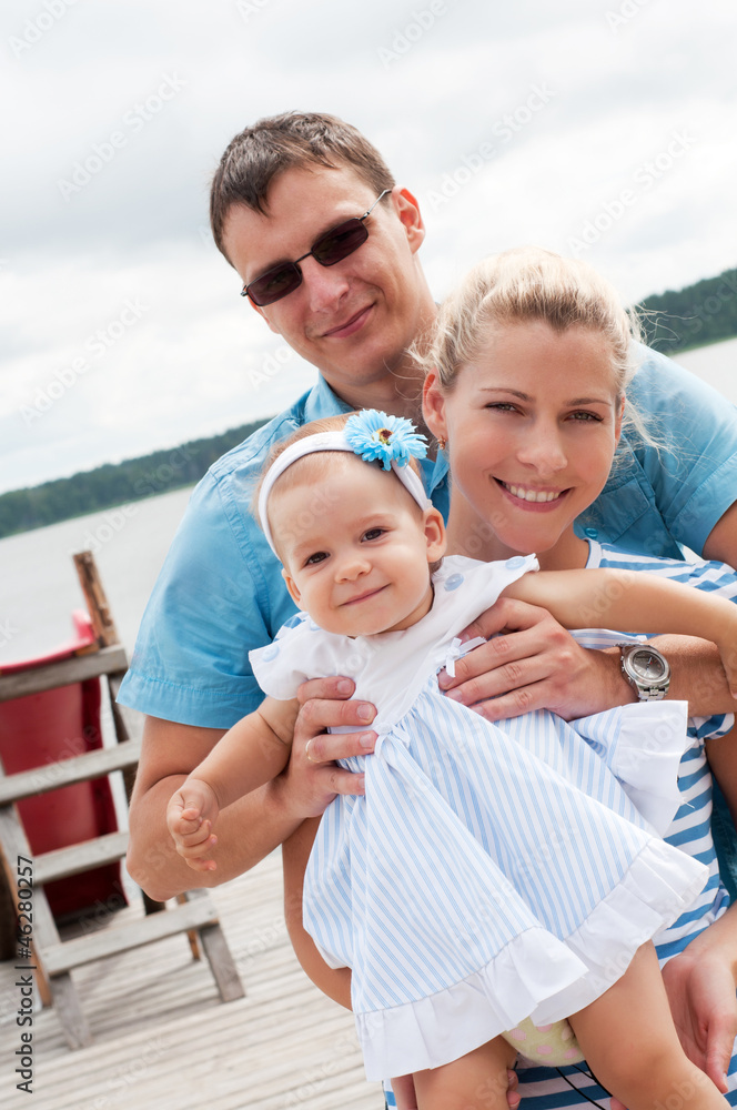 Fototapeta premium Happy family on the river bank