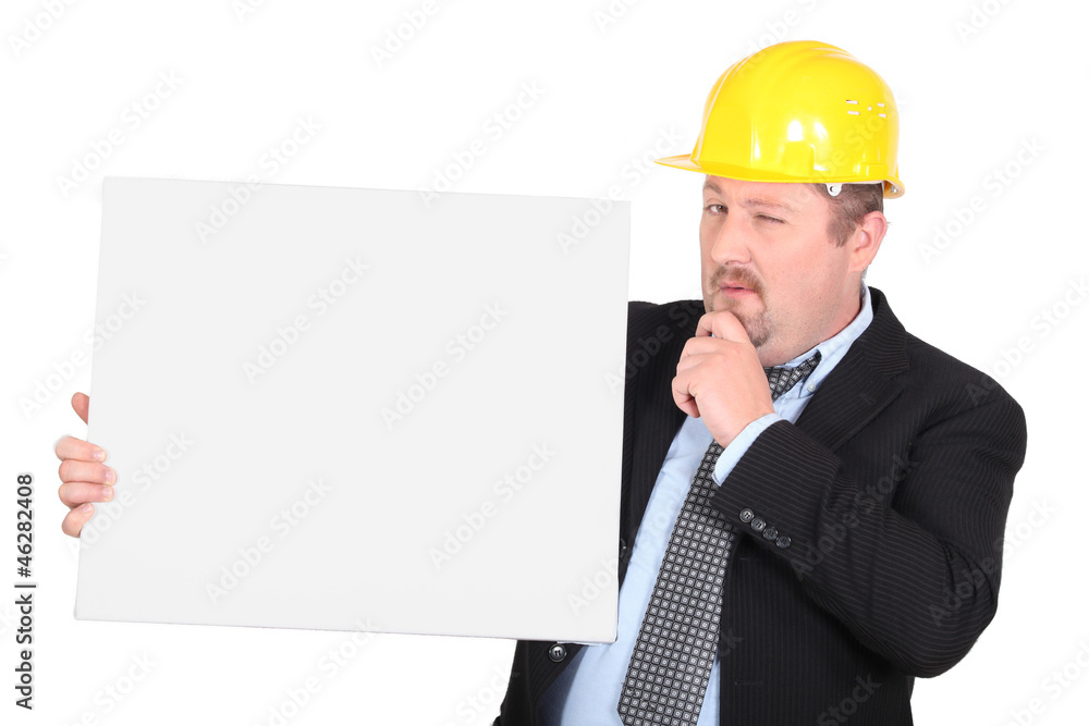 Man in hard hat holding blank message board Man in hard hat holding blank message board