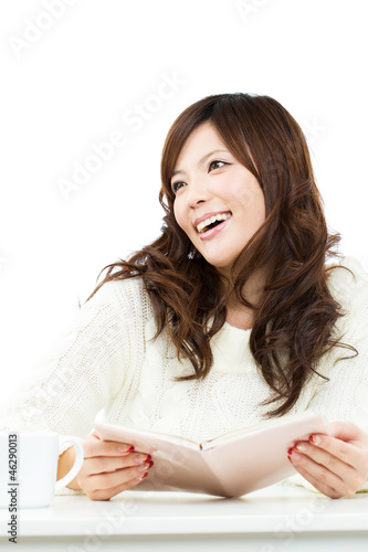 Beautiful young woman reading a book. Portrait of asian.