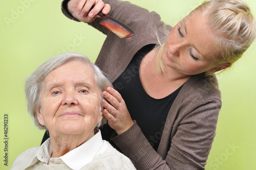 Senior woman with her caregiver in home.