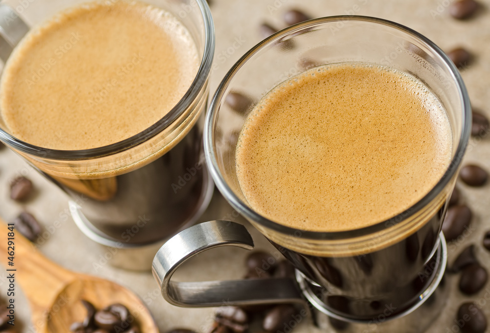 Freshly brewed espresso coffee with roasted beans. Freshly brewed espresso coffee with roasted beans.