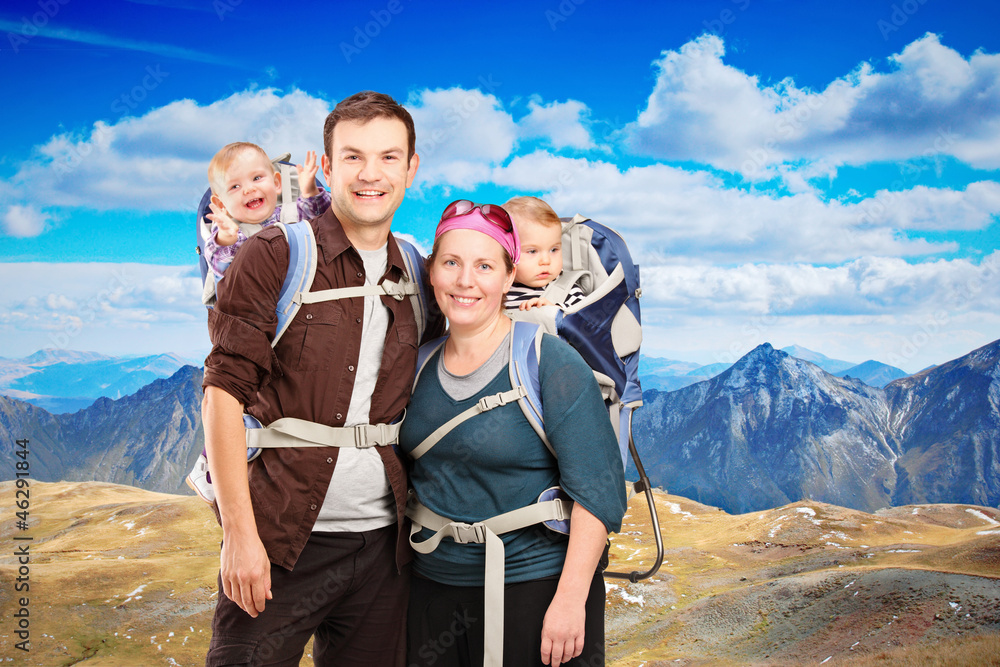 Happy family on a hiking day, mountain ridge in the background