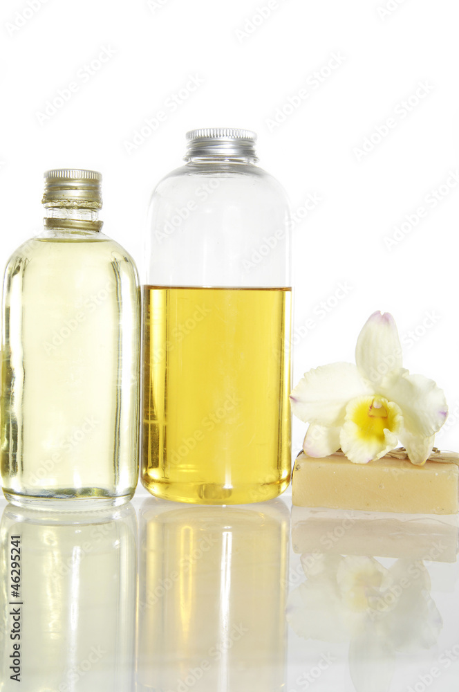 Reflection of Perfume bottle and beautiful orchid flower Reflection of Perfume bottle and beautiful orchid flower