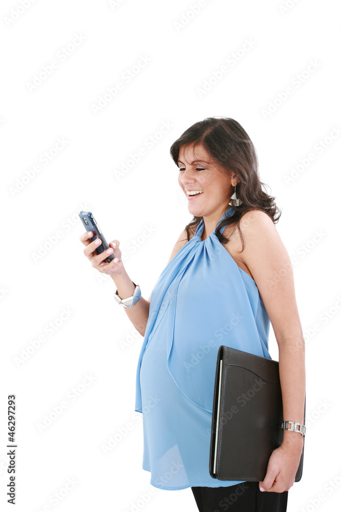 a pregnant woman texting on her cell phone with a happy expressi a pregnant woman texting on her cell phone with a happy expressi