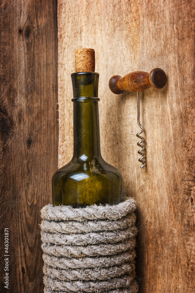 Naklejka premium bottle of wine wrapped with rope
